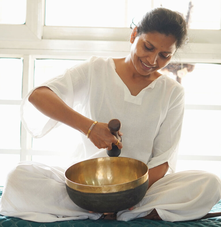 Vidya Kale playing a singing bowl during sound healing